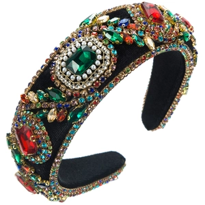 Detail of baroque velvet headband with luxury emerald and ruby crystal embellishments