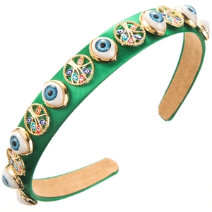Green satin headband featuring Evil Eye beads and Tree of Life charms for party hair accessory