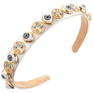 Detail of white satin headband with Evil Eye beads and golden tree of life charms