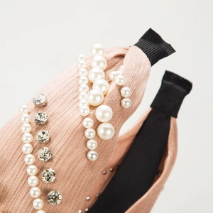 Elegant pearl and rhinestone knit headband in mauve for a stylish hair accessory look