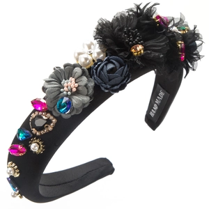 Close-up of handmade baroque headband with colorful rhinestones, pearls and fabric flowers