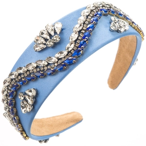 Close-up of light blue satin headband with wave-patterned blue and white rhinestones