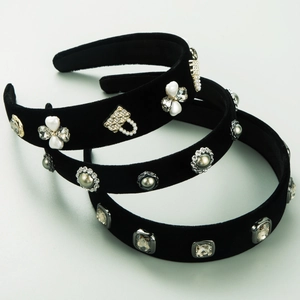 Close-up of velvet headbands with pearl flower and rhinestone handbag charm details