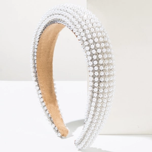 Macro view of wide headband featuring white pearls, crystals, and tan velvet lining