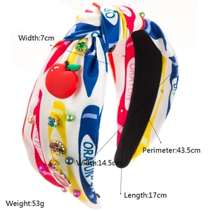 Diadema con nudo a la moda con motivos de crayón, amuletos de manzana y perlas
