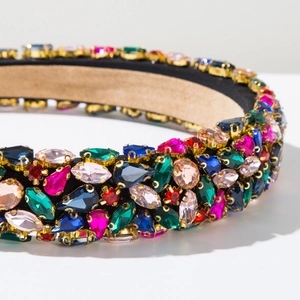 Close-up of luxury Baroque sponge headband with multi-colored rhinestones and golden claws