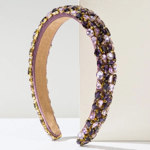 Macro shot of purple crystal embellished sponge headband with non-slip suede lining