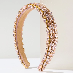 Close-up of luxury Baroque padded headband with pink crystals and gold claw settings