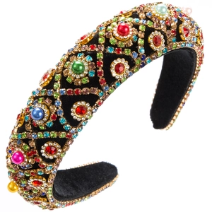 Close-up of velvet headband with colorful rhinestones and pearls in baroque style