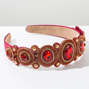 Detailed view of red velvet headband with large oval crystals and golden micro-beads