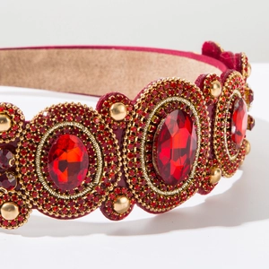 Macro detail of red Baroque headband with large crystals and gold beaded metalwork