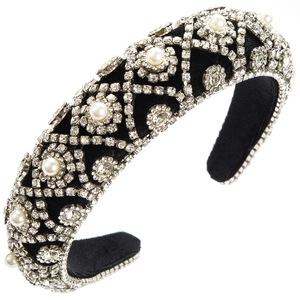 Detailed view of luxury velvet headband with sparkling rhinestones and white pearls