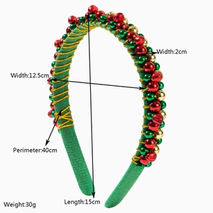 Christmas headband with gold wire, festive bells, and colorful beads on green fabric