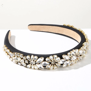 Detailed macro view of sparkling crystal floral embellishments on a black satin headband