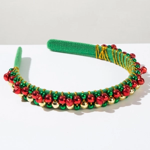 Detail of Christmas headband with green velvet fabric, golden wire, and colorful bells