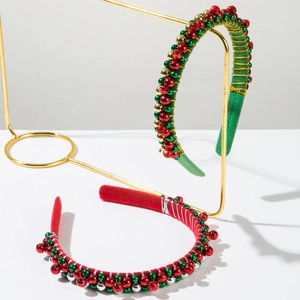 Detail of red and green Christmas headbands with metallic gold thread and bells