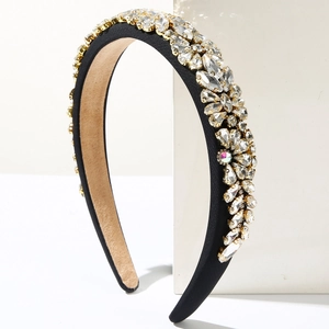 Detailed close-up of padded black velvet headband with sparkling marquise crystal embellishments