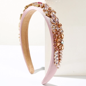 Detail of pink padded headband featuring elaborate champagne and violet crystal flower patterns