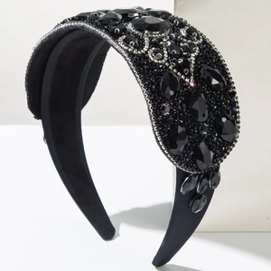 Baroque wide black headband with sparkling resin rhinestones on a velvet surface