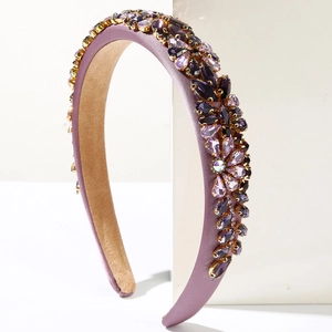 Detailed view of luxury purple padded headband with colorful rhinestones in gold metal claws