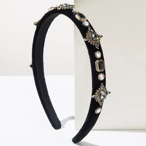 Close-up of luxury velvet headband with sparkling rhinestones and golden metal crystals