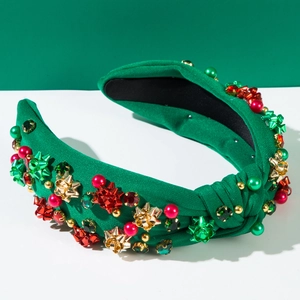 Dettaglio del cerchietto verde a nodo con perline natalizie, strass e fiocco