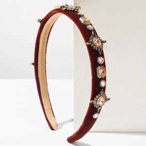 Close-up of burgundy velvet headband embellished with pink and multicolor rhinestones