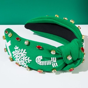 Close-up of festive green Christmas headband with beadwork snowflakes and rhinestones
