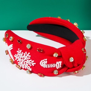 Detail of red Christmas knotted headband with beaded snowflake and sparkling rhinestone decor