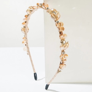 Close-up of elegant champagne crystal headband with sparkling faceted amber beads