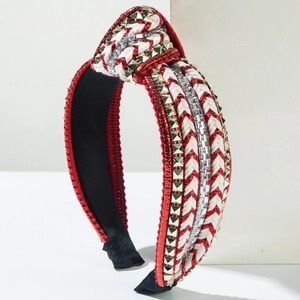 Detail of red and white braided headband with sparkling rhinestones and gold studs