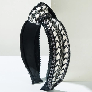 Close-up of black and white woven knot headband with silver square bead embellishments