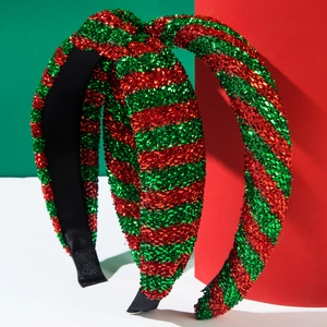 Detail of red and green glitter Christmas headbands with non-slip teeth on colorful background