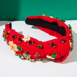 Detail of red Christmas headband with rhinestones, gingerbread man charms, and knotted fabric