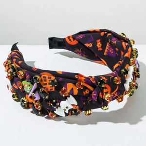 Detailed view of Halloween headband with pumpkin prints, rhinestones and resin ghosts