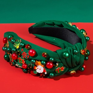 Detail of Christmas headband with green fabric, pearls, and holiday enamel charms