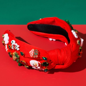 Détail d'un serre-tête de Noël rouge avec Père Noël en perles et ornements bijoux