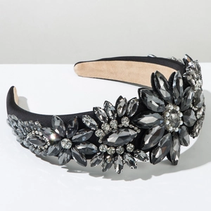 Detail of baroque headband with dark crystals and faux pearls on black velvet