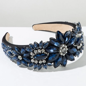 Detail of baroque headband featuring blue crystals and pearls on black fabric