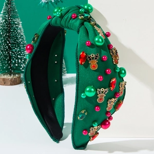 Christmas reindeer knotted headband with green pearls and rhinestones on dark green fabric