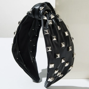 Fashionable black leather knotted headband with silver pyramid studs on white background