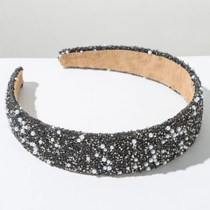 Detail of luxury padded headband with grey crystals and white pearls on velvet lining