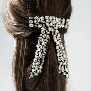 Elegant black velvet bow hair clip with luxury rhinestones worn on brown long hair