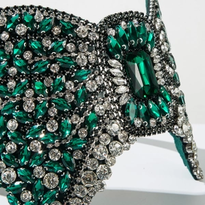 Macro shot of emerald marquise crystals and white rhinestones on luxury velvet headband
