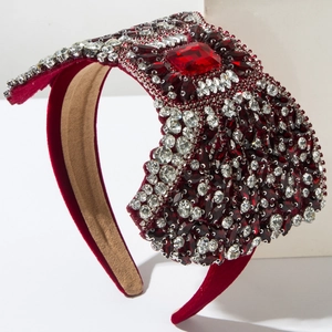 Detailed close-up of a luxury burgundy velvet headband with red crystals and rhinestones