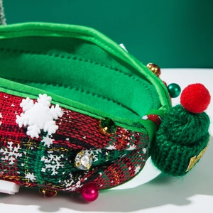 Close-up of Christmas headband featuring tweed fabric, mini green hat, and snowflake details