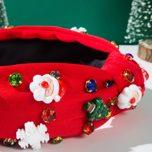 Detail of red Christmas knotted headband with 3D Santa, tree decor and colorful rhinestones