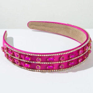 Detail of rose red satin headband with crystal rhinestones and purple gemstones