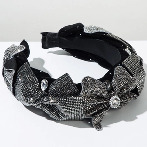 Macro shot of wide velvet headband with silver rhinestones and crystal bow detail