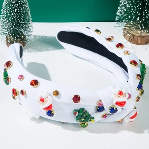 Detail of white knotted headband with resin Santa Claus charms and colorful rhinestones